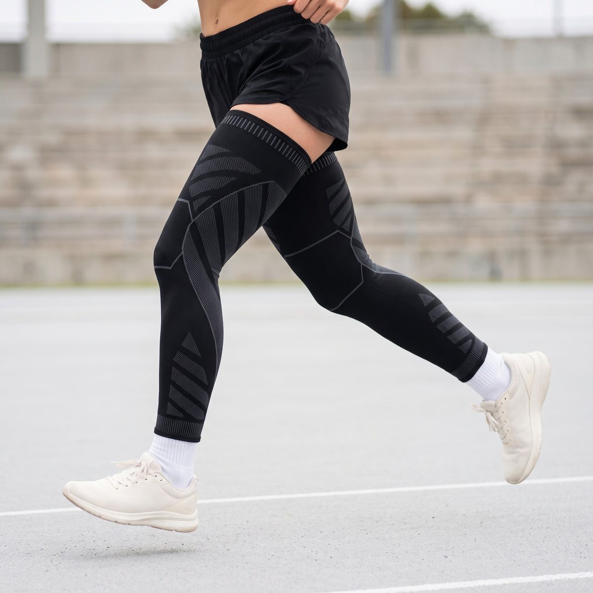 MotionKnit compression leg sleeves worn by a runner mid-stride on a track